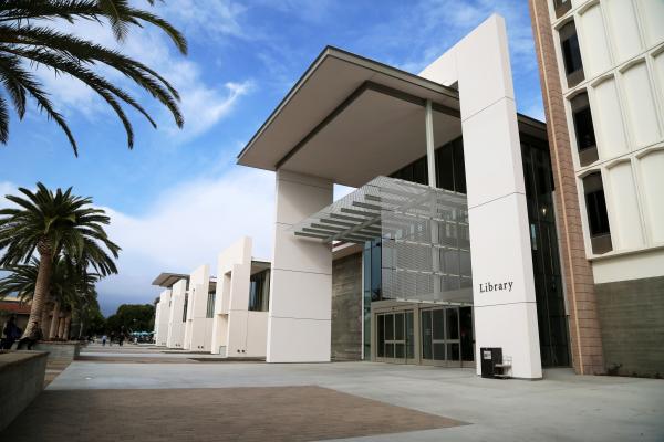 Image of Library entrance from the ground, with palm trees on the left