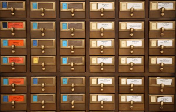 Front-facing image of card catalogue with drawers and labels