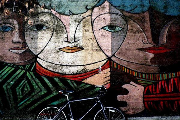 Image of mural wall, with bike leaning against the wall. 