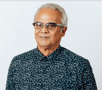 head shot of Ben Refuerzo with horn-rimmed black and white glassed, short-cropped gray-white hair and a blue collared shirt with white spots