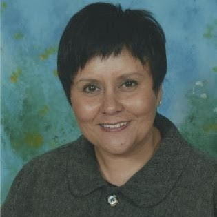 head shot of Rebecca R. Refuerzo with short-cropped black hair and a black collared shirt